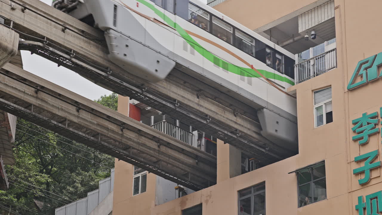 CHONGQING, CHINA - 28 MAY 2025 : train enters liziba station inside a building on bridge in Chongqing china