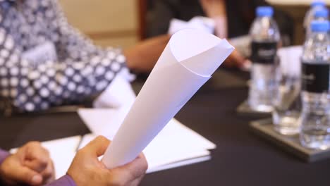 male hands holding sheet of paper