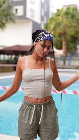 teen girl dancing by pool