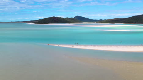 rotating drone shot of people on beautiful sandy beach at whitehaven beach whitsunday island australia