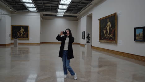 woman taking photos in an art gallery