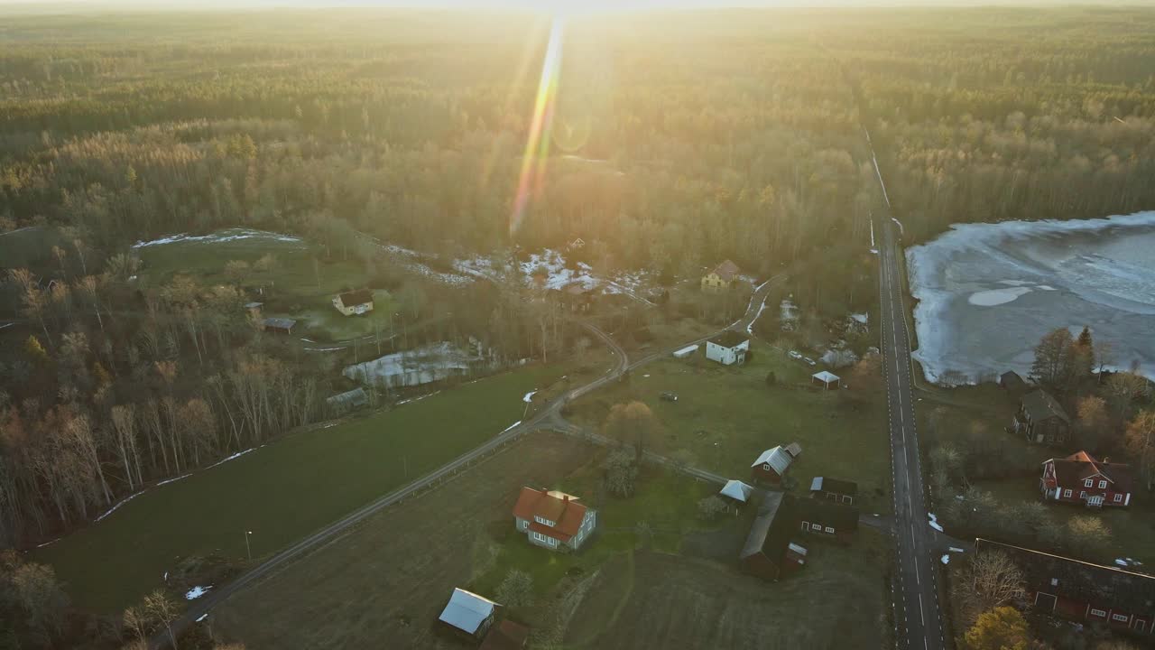 Drone flying over a small and abandoned town surrounded by large forests in rural Sweden