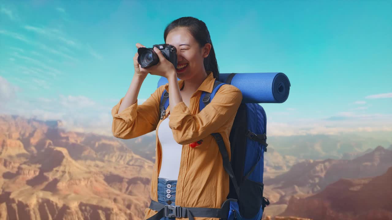 Side View Of Asian Female Hiker With Mountaineering Backpack Using A Camera Taking Picture While Traveling At The Top Of Mountain
