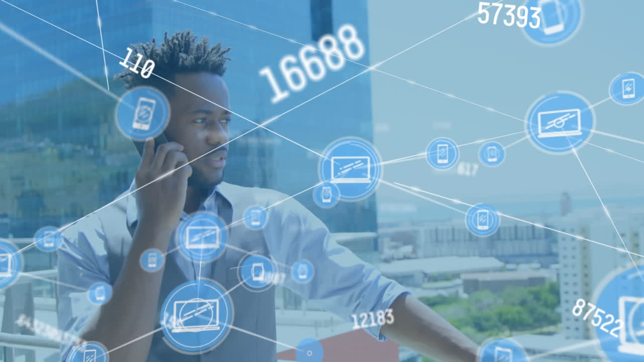 Animation of network of icons over african american man talking on smartphone at office terrace