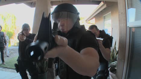 dea officers with arms drawn perform a drug raid on a house 2