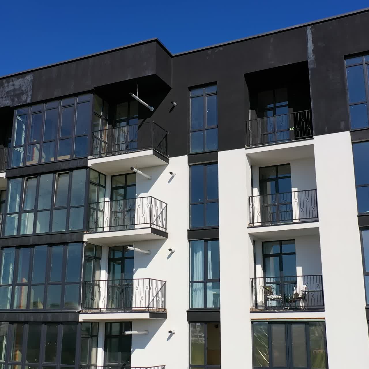 Contemporary residential building in the city. Exterior of a modern design of multistorey apartment building. Aerial view