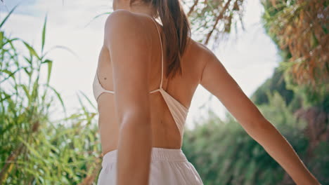 yoga woman clasping hands sunlight bamboo nature close up. girl stretching arms