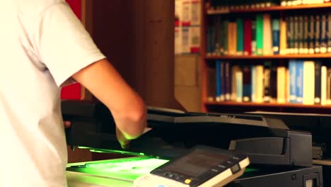 student using the photocopier in the library