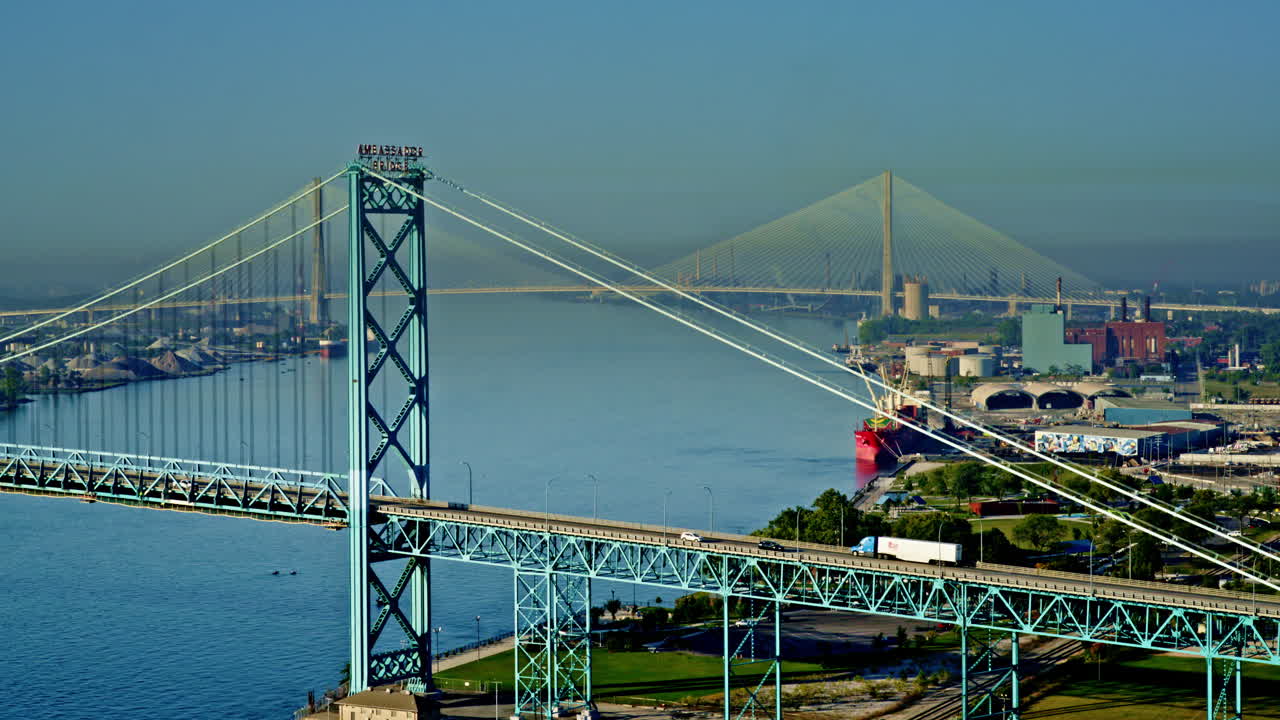 Smooth aerial pan over Detroit River highlighting freighter movement and downtown skyline