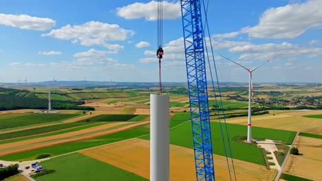 crawler crane assembling wind turbine at wind farm in austria