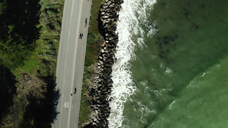 drone view of waves crashing in santa cruz, california