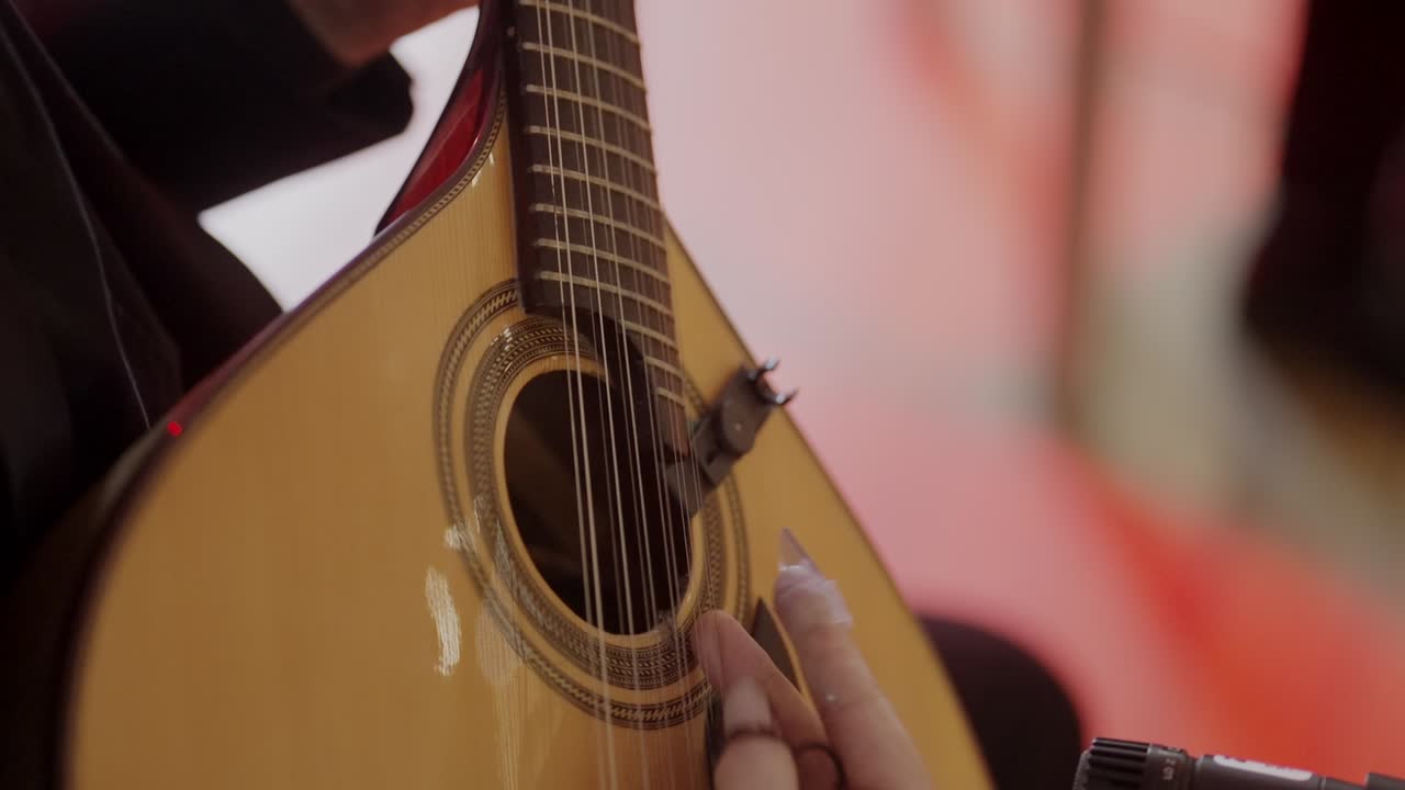 Close up of musician playing Portuguese guitar during fado performance