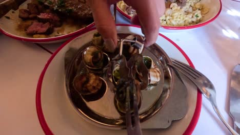 enjoying escargot at a parisian restaurant