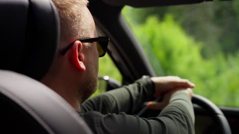 man driving through the forest