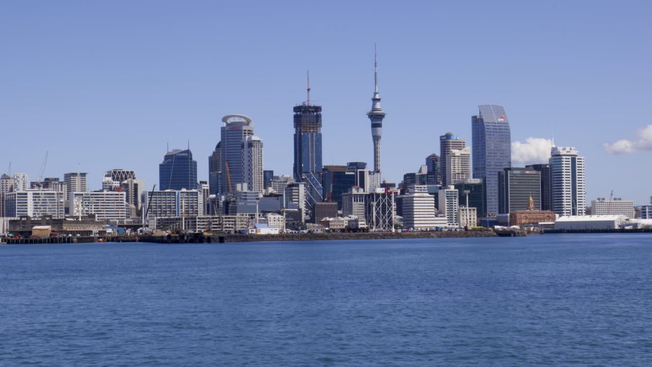 Telephoto Panning shot of Auckland skyline, Sky Tower and Commercial Bay, Auckland, New Zealand