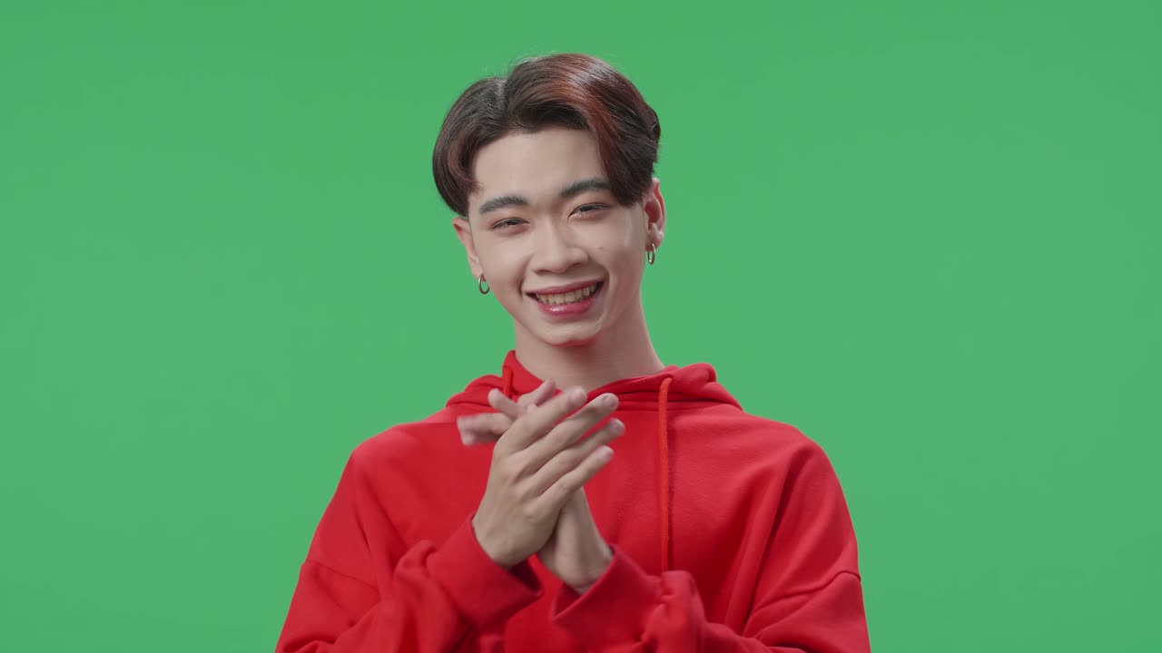 Young Asian Transgender Male Clapping Her Hands In The Green Screen Studio