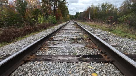 new hampshire railroad during fall colors, fpv aerial shot