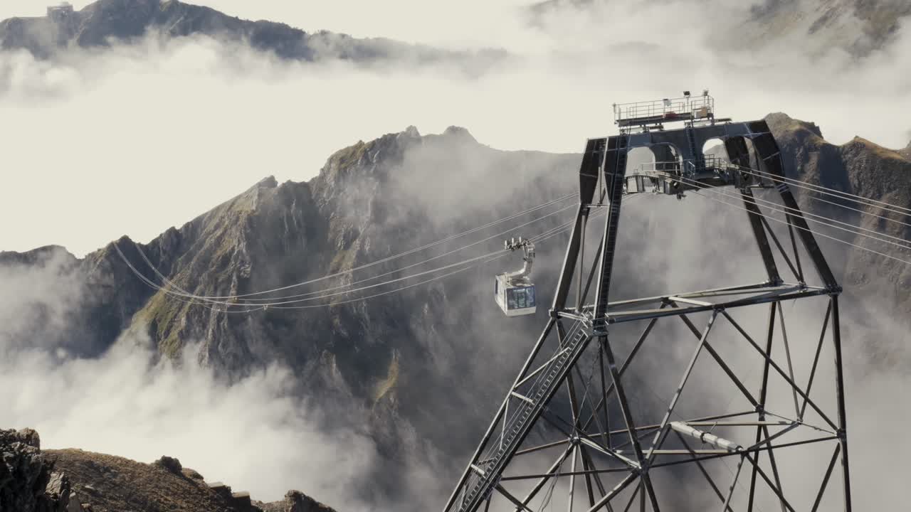 Cable Car Descending at Pic du Midi de Bigorre over Valley Clouds in the French Pyrenees