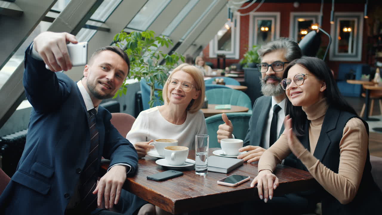 Business Team Taking a Selfie During a Meeting in a Cafe