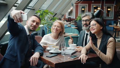 business team taking a selfie during a meeting in a cafe
