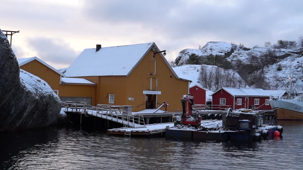 Slow motion shot of waves surrounding a pier in Lofoten, Norway