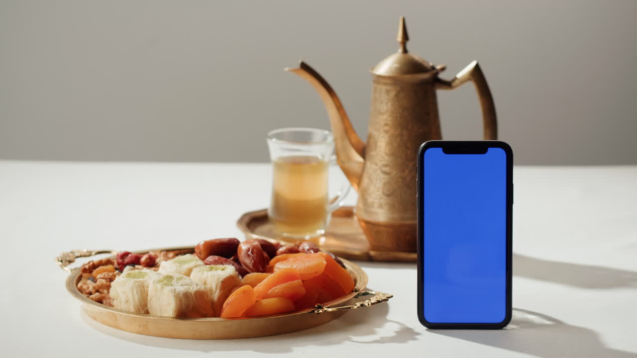 Traditional Middle Eastern Dessert and Tea with Smartphone