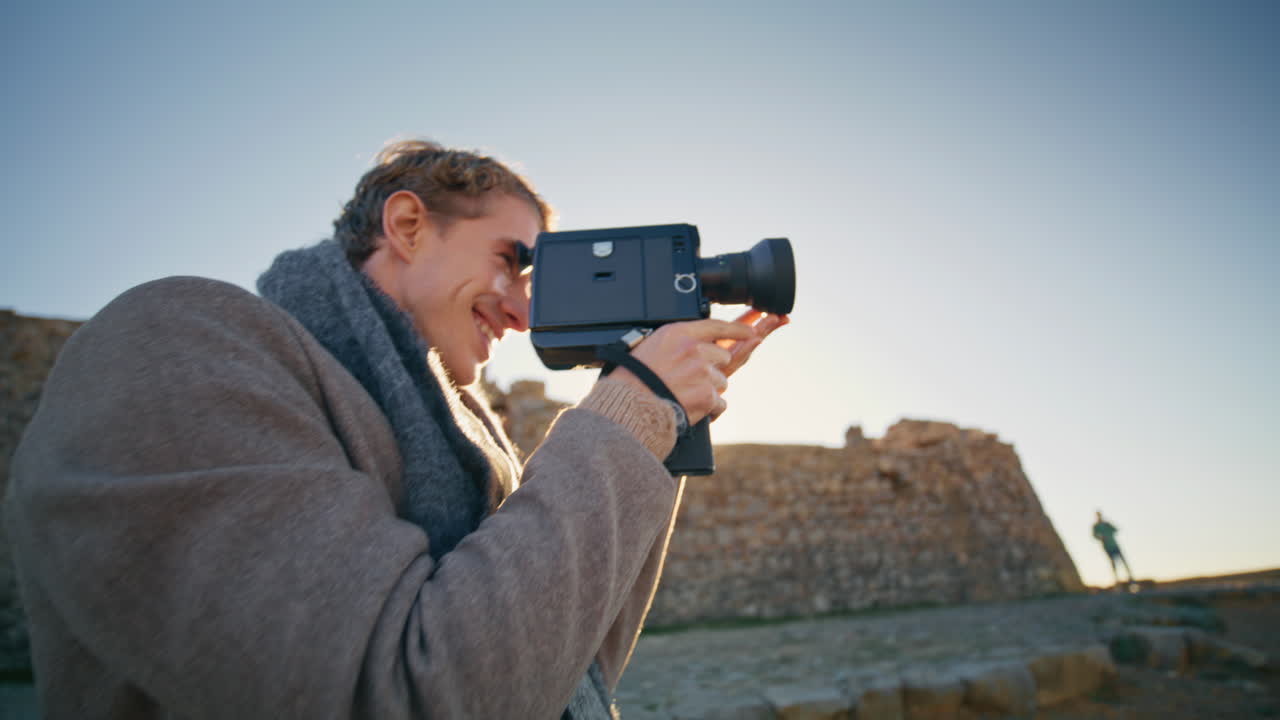 Happy photographer taking photo evening rocky beach closeup. Carefree newlyweds