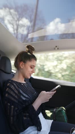 Young woman using phone in a car