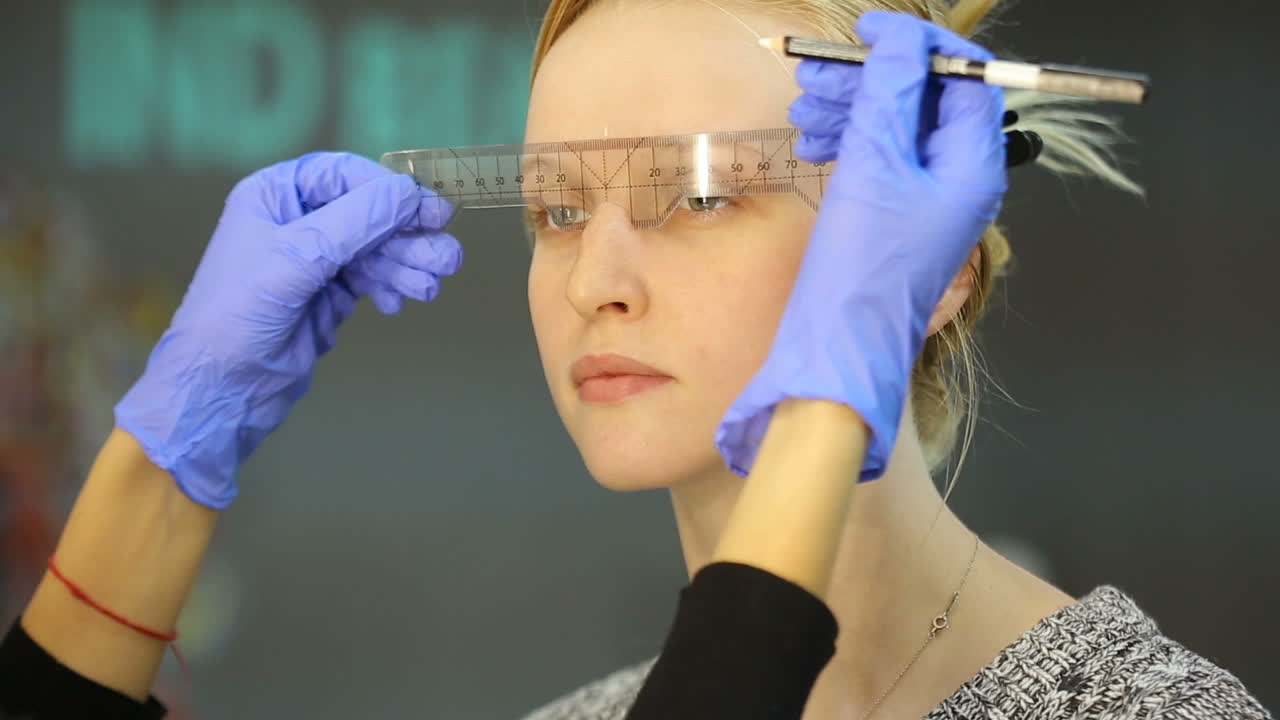 Permanent eyebrow make up. Cosmetologist preparations for permanent eyebrow make up