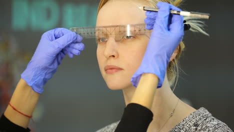 permanent eyebrow make up. cosmetologist preparations for permanent eyebrow make up