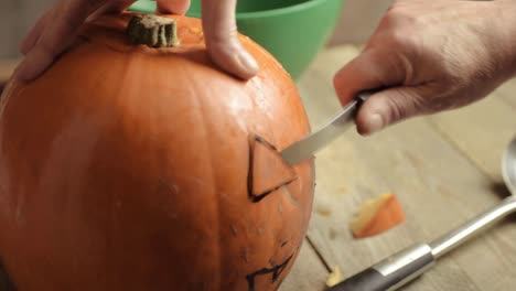 carving a pumpkin for a halloween jack o lantern