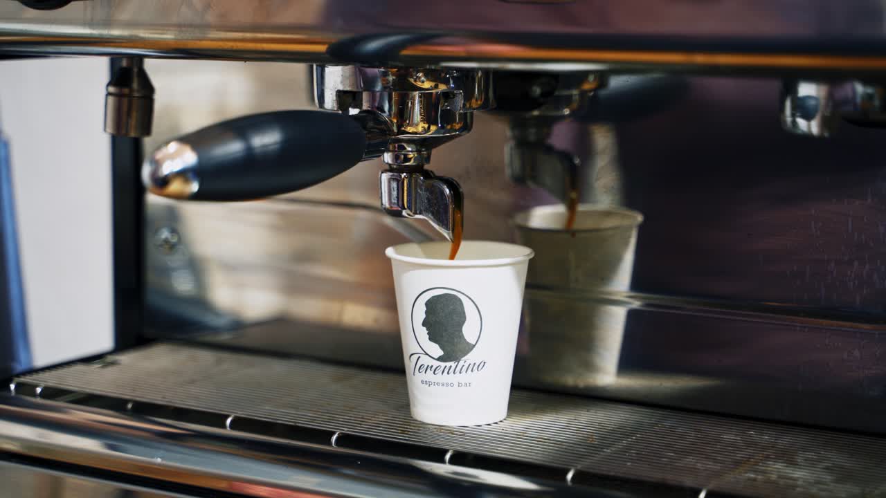 Professional coffee brewing. Close up of making coffee from coffee machine