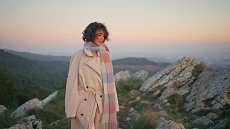 woman walking evening hills at tranquil weekend. elegant lady exploring nature