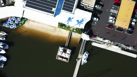 flying from yacht club over luxury boats and million dollar apartments, top down views of australian suburb