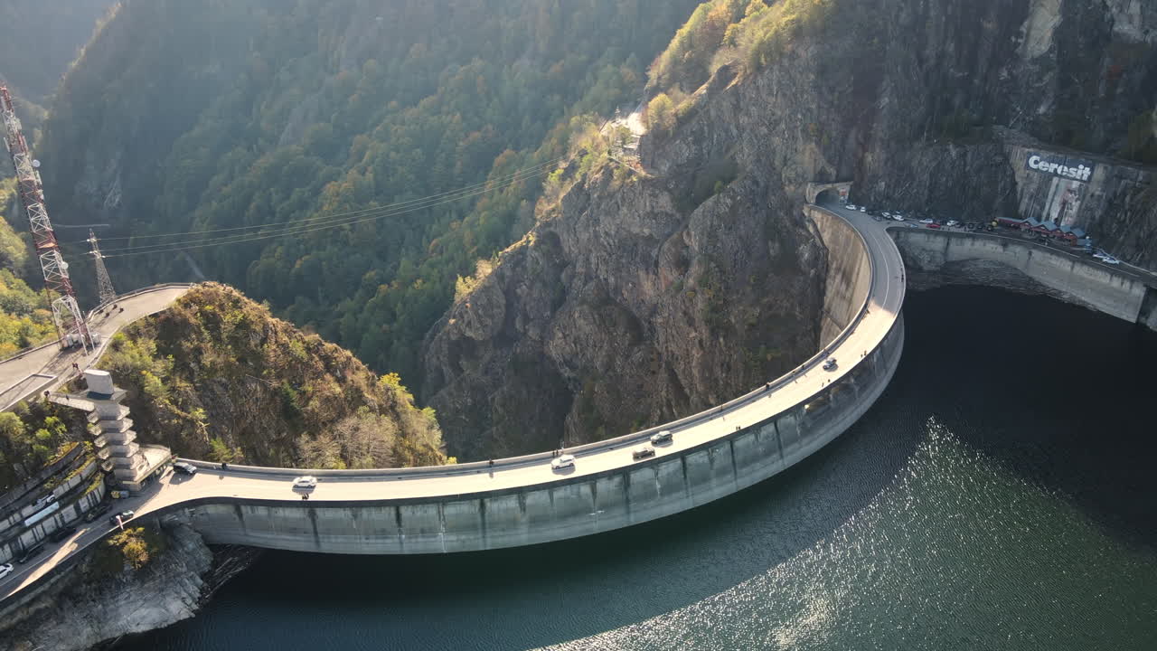 Aerial drone view of nature in Romania. Valley in Carpathian mountains with Vidraru dam and lake, slopes with lush forest