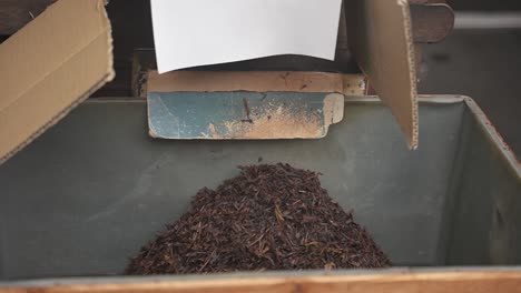 roasted japanese tea falling from mill, close slow motion shot, uji, kyoto