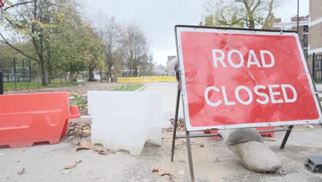 road closed signs for street repair construction in autumn