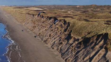 kiteboarding on the beach with sand dunes