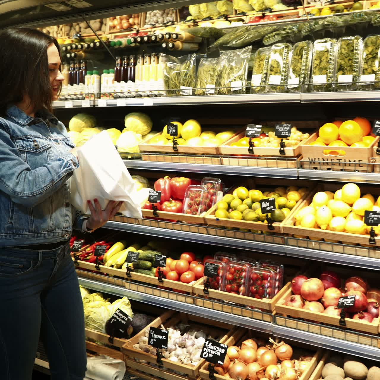 Beautiful young woman shopping for fruits and vegetables in a production department. Grocery store. Supermarket. Healthy lifestyle. Square video