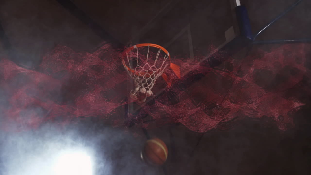 Basketball going through hoop with animation of swirling red and white smoke