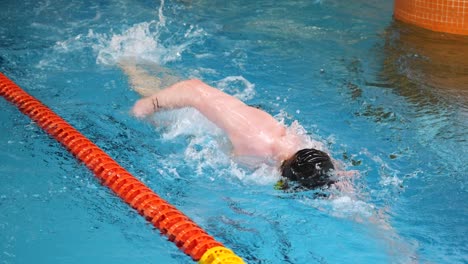 man swimming freestyle in a pool