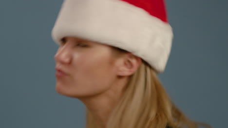 cu woman flicks head with santa hat