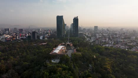 drone soars over castillo de chapultepec with reforma skyline on the background