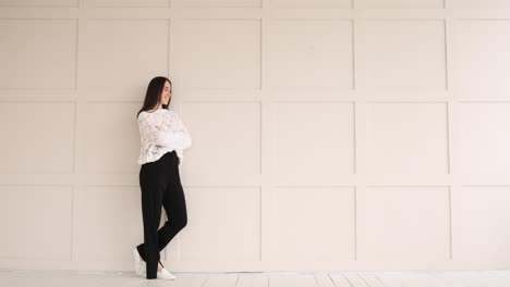 beautiful young woman leaning on wall