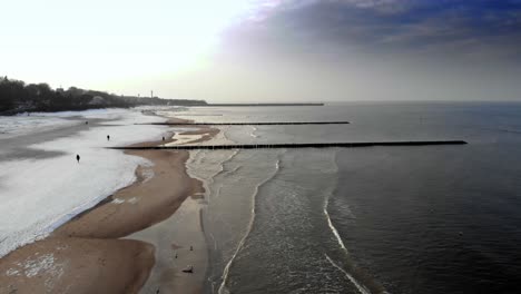 Aerial-shot-of-sandy-beach-in-Ustka-in-winter