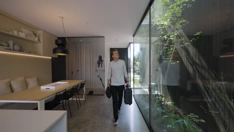 male floor plan technician walks into modern home confidently excited to start work