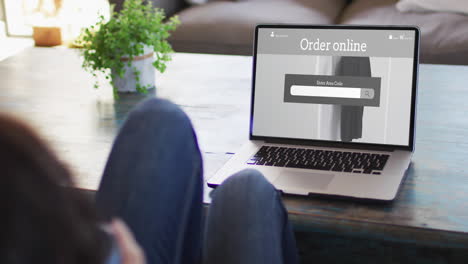 knees of woman at table using laptop, online shopping for clothes, slow motion