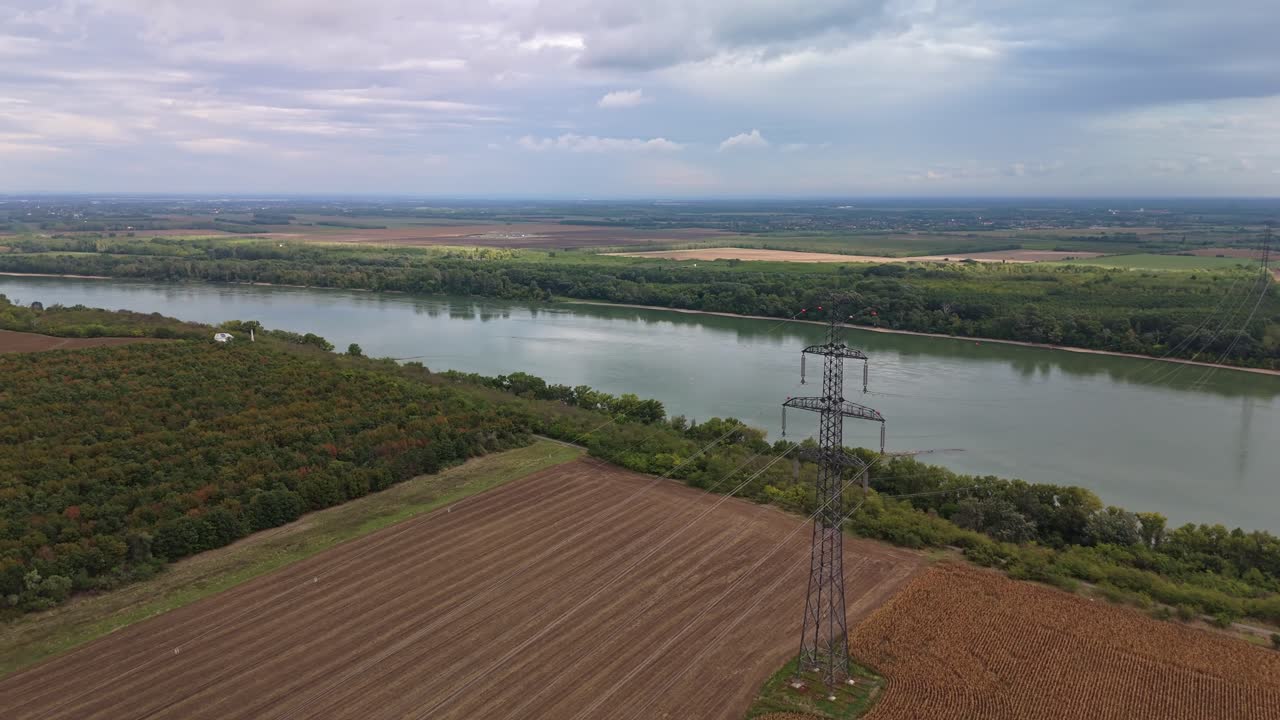Orbital aerial view of a large electric pole that spans across the River Danube near Százhalombatta in Hungary