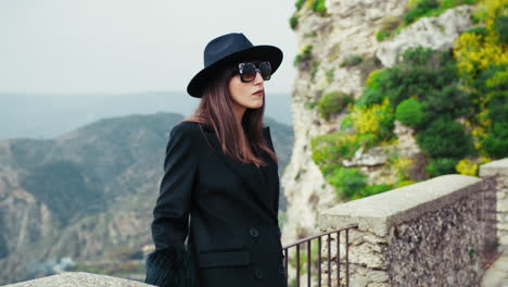 elegant woman with sunglasses and a suggestive natural background behind