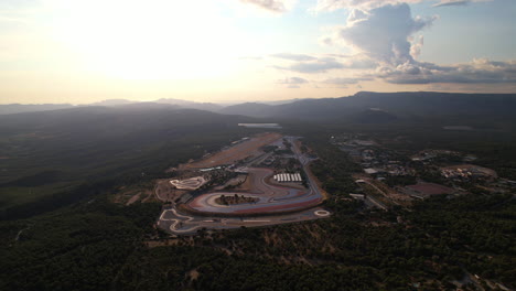 Overhead-shot-of-vibrant-racetrack-and-surrounding-solar-setups.